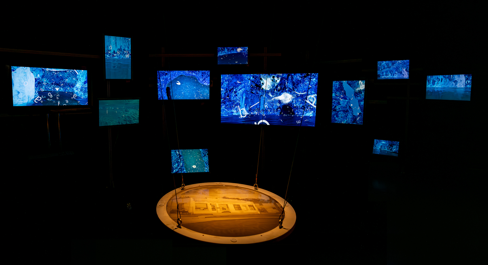 12 channel installation of monitors with a relief sculpture